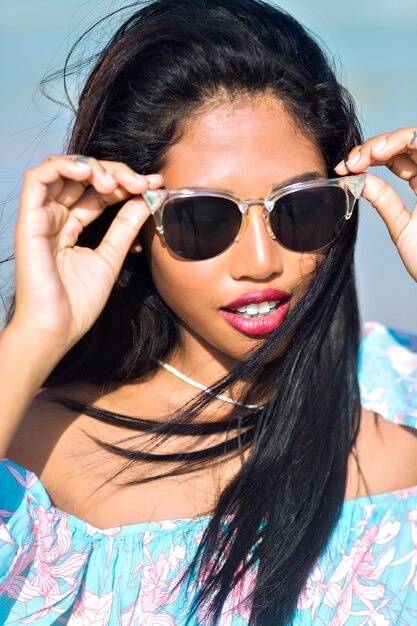 portrait of asian thai girl with sunglasses having fun on tropical beach