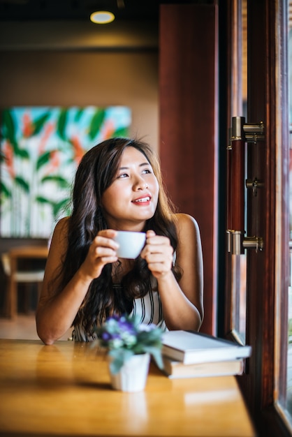 Portrait asian woman smiling relax in coffee shop cafe