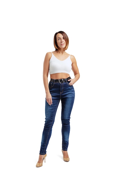 Portrait of attractive middle-aged woman wearing white t-shirt and jeans posing isolated on white studio