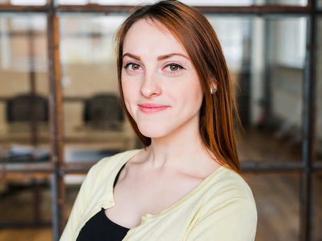 Portrait of attractive smiling woman in office