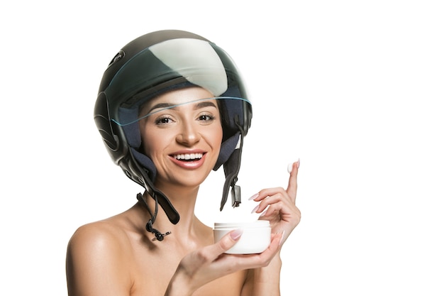 Free photo portrait of attractive woman in motorbike helmet on white studio