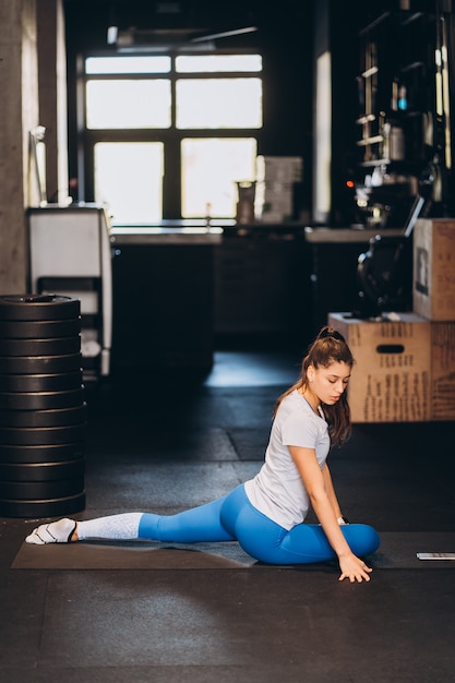 Portrait of attractive young woman doing yoga or pilates exercise