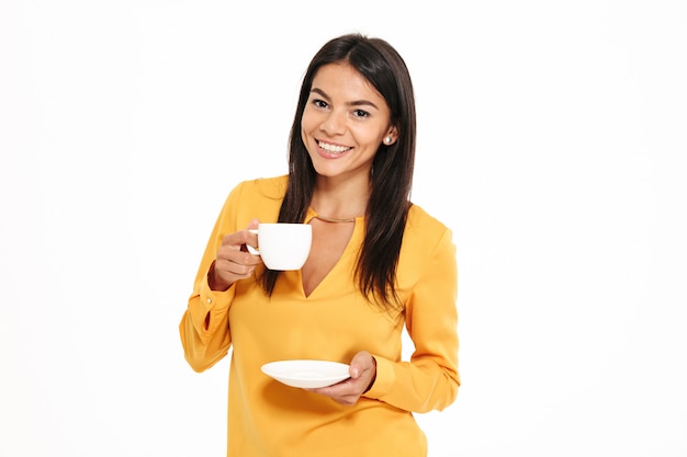 Portrait of an attractive young woman holding tea cup