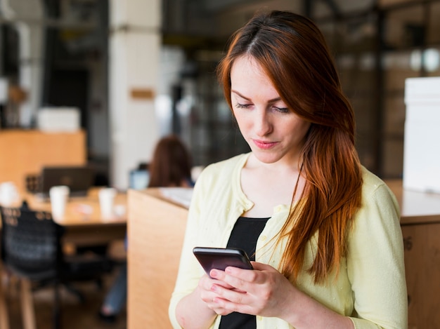 Portrait of attractive young woman using smartphone