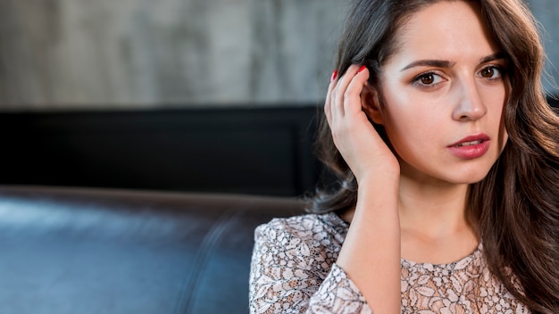 Portrait of an attractive young woman with her hand in hair