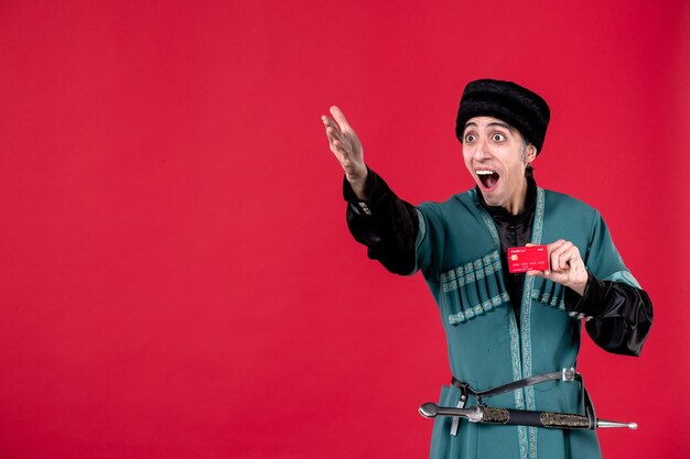 Portrait of azeri man in traditional costume holding credit card studio shot red spring ethnic novruz