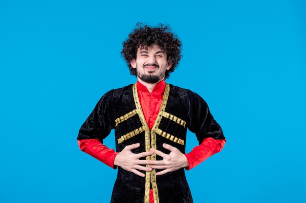 Free photo portrait of azeri man in traditional costume studio shot blue background novruz spring ethnic concept