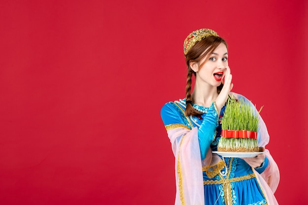 Free Photo portrait of azeri woman in traditional dress with semeni on red