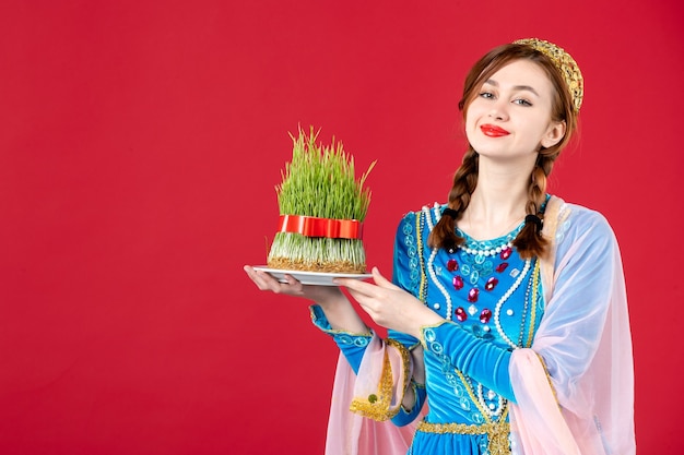 Free Photo portrait of azeri woman in traditional dress with semeni on red