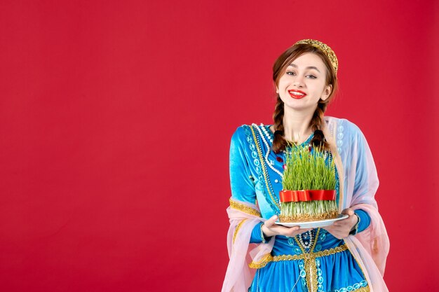 Portrait of azeri woman in traditional dress with semeni on red