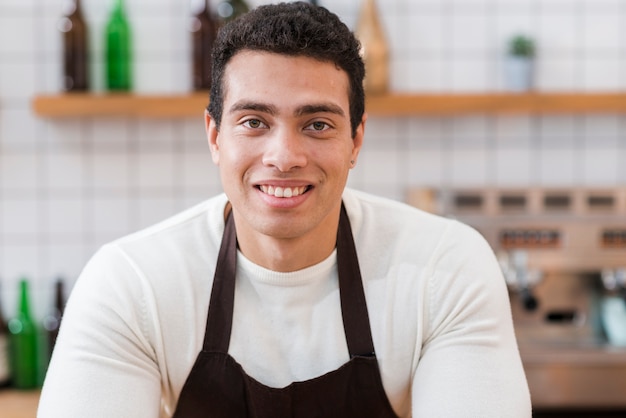 Portrait of barista boy in cafe