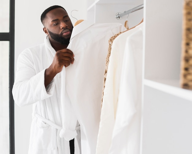 Portrait of bearded man checking his wardrobe