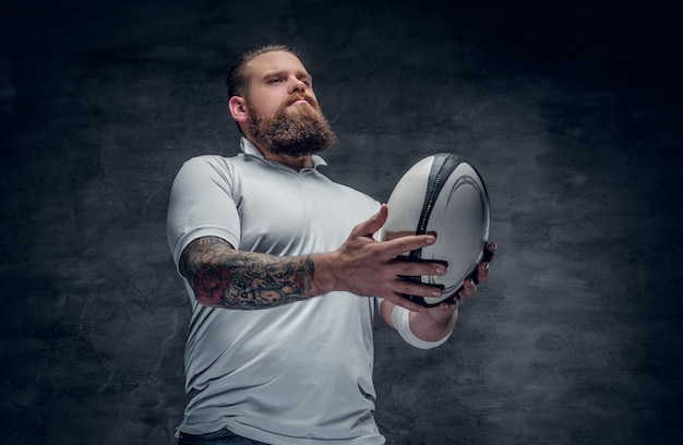 Portrait of bearded rugby player with tattoos on his arms