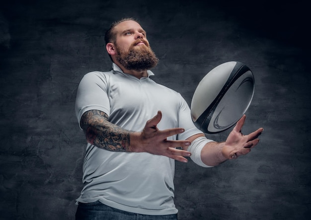 Portrait of bearded rugby player with tattoos on his arms