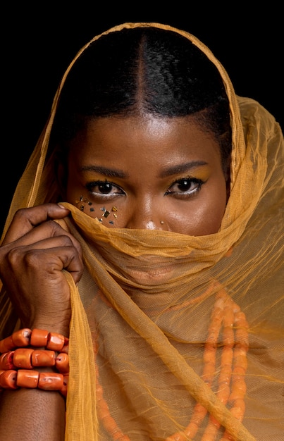 Portrait of beautiful african woman wearing traditional accessories and yellow veil