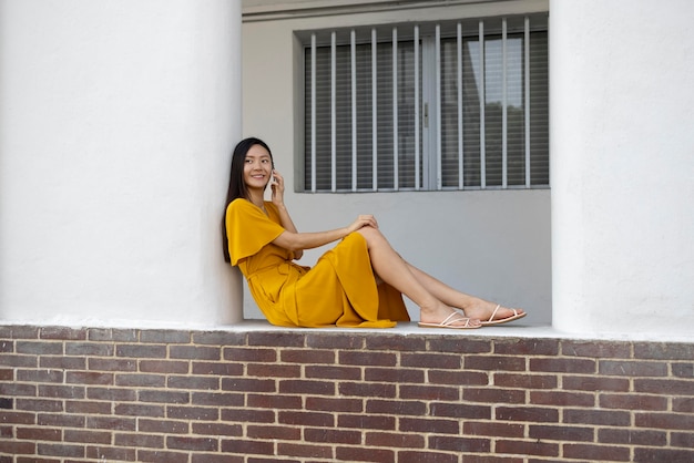 Free photo portrait of beautiful asian woman using smartphone outdoors in the city