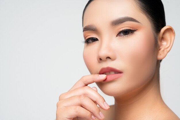 Portrait of beautiful asian woman with black hair and pink lips