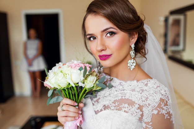 Portrait of beautiful bride in white wedding dress bright make up.