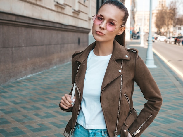 Portrait of beautiful brunette model dressed in summer hipster jacket clothes     