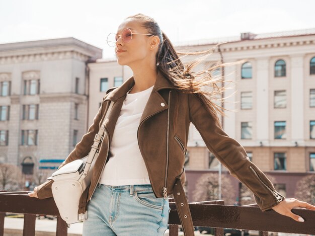 Portrait of beautiful brunette model dressed in summer hipster jacket clothes. 