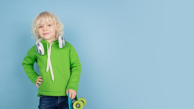 Free Photo portrait of beautiful caucasian little boy isolated on blue  wall