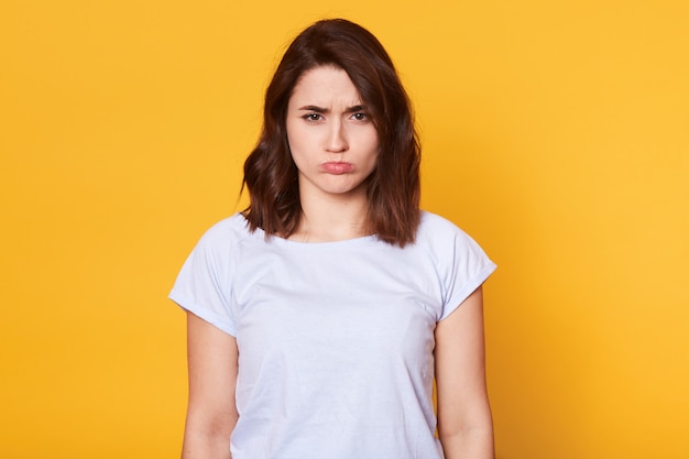 Portrait of beautiful dark haired young woman in casual white t shirt