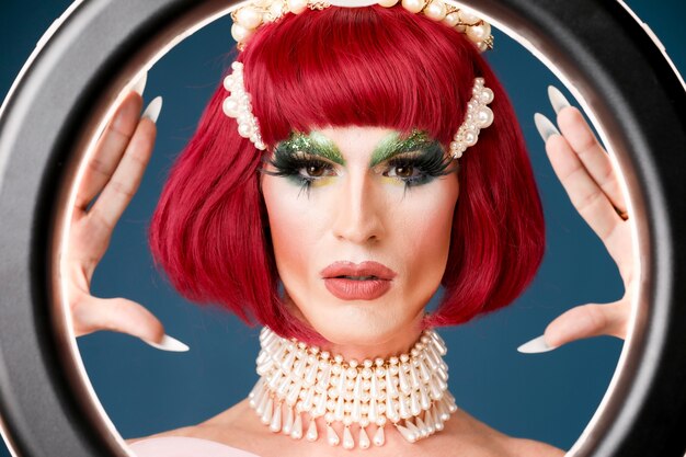 Portrait of beautiful drag person wearing makeup and wig