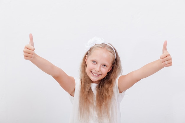 Portrait of a beautiful girl showing thumbs up