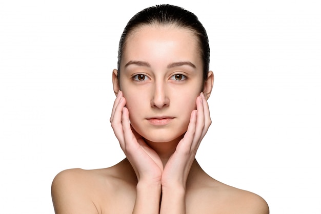 Free photo portrait of beautiful girl stroking her face with healthy skin