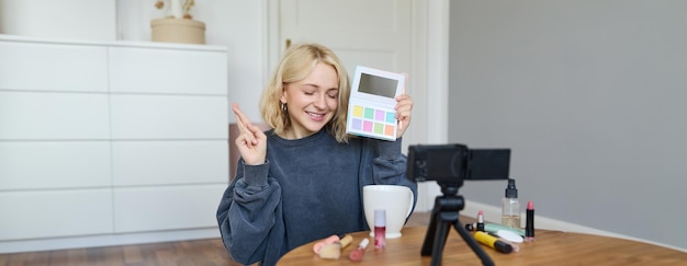 Free Photo portrait of beautiful lifestyle blogger girl records a video on her camera for social media shows