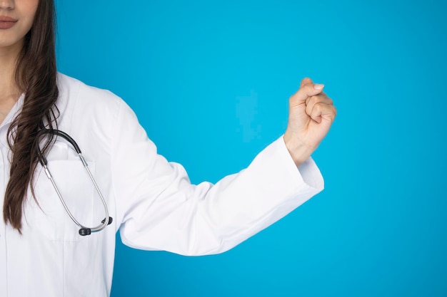 Portrait of beautiful mature woman doctor in lab coat for hospital shooting in studio