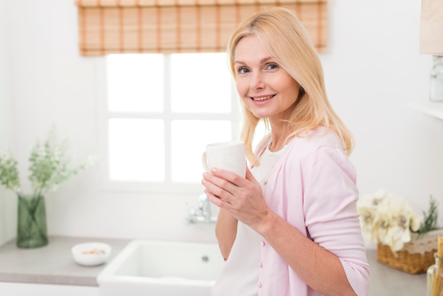 Portrait of beautiful mature woman in the kitchen