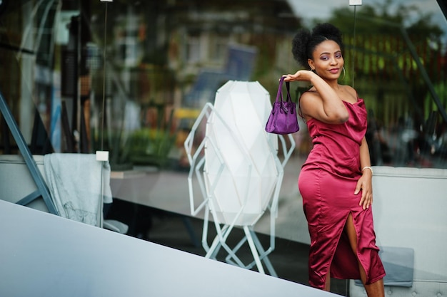 Free photo portrait of a beautiful natural young african woman with afro hair black model in red silk dress