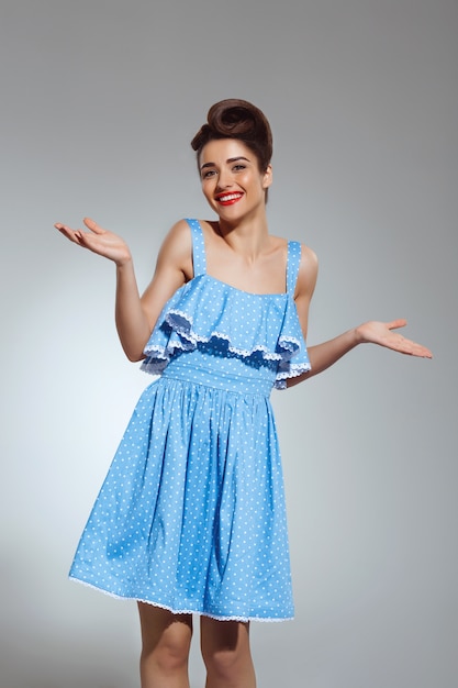 Portrait of beautiful pin-up woman at studio