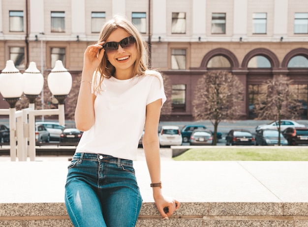 Portrait of beautiful smiling blond model dressed in summer hipster  clothes. 