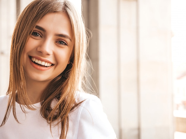 Portrait of beautiful smiling blond model dressed in summer hipster  clothes.  