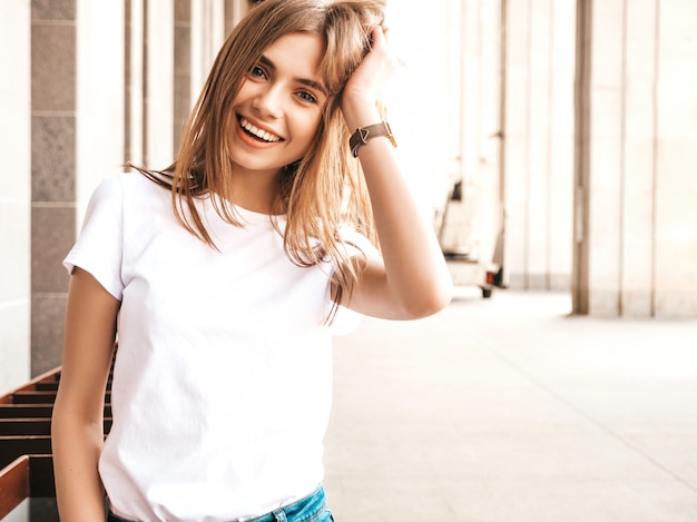 Portrait of beautiful smiling blond model dressed in summer hipster clothes.  