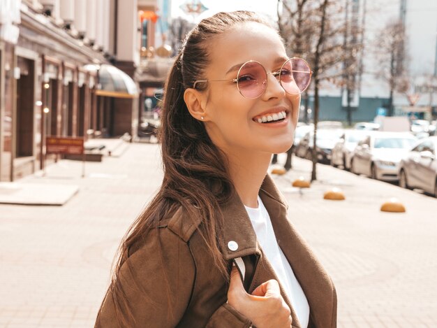 Portrait of beautiful smiling brunette model dressed in summer hipster jacket clothes     