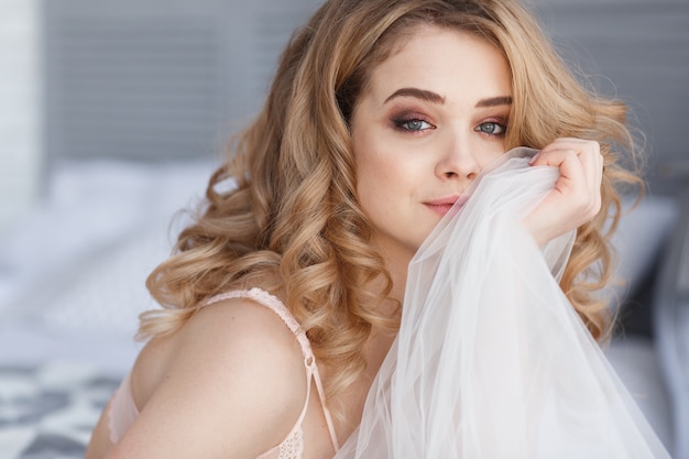 Free Photo portrait of beautiful smiling pretty woman relaxing in bedroom. brides morning.