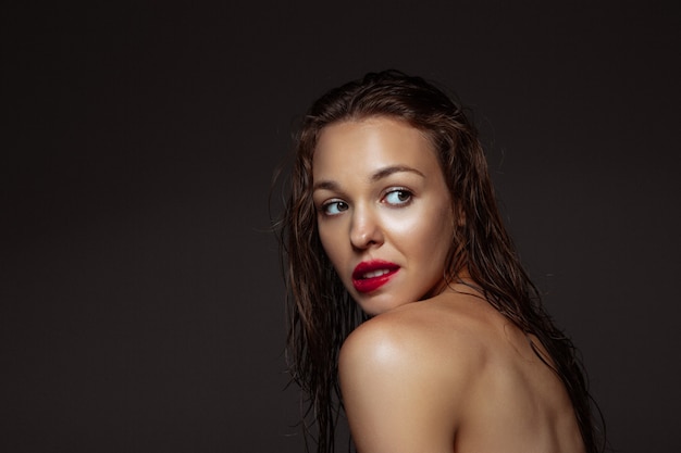 Portrait of beautiful stylish woman isolated on dark studio background