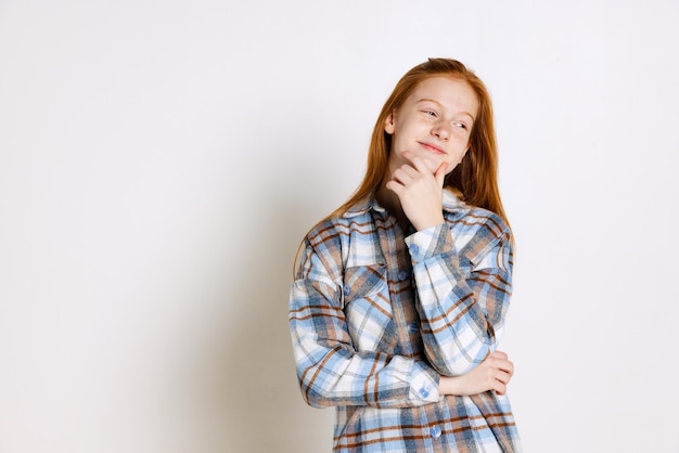 Free Photo portrait of beautiful teen girl in checkered shirt posing isolated over white studio background