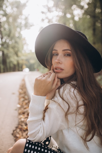 Portrait of a beautiful woman in an autumn park