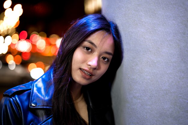 Portrait of beautiful woman in the city at night