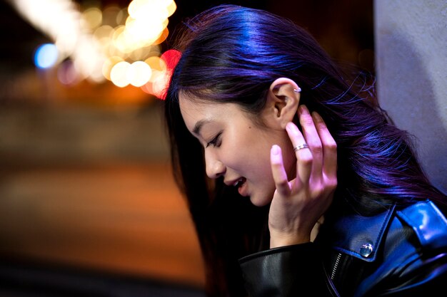 Portrait of beautiful woman in the city at night