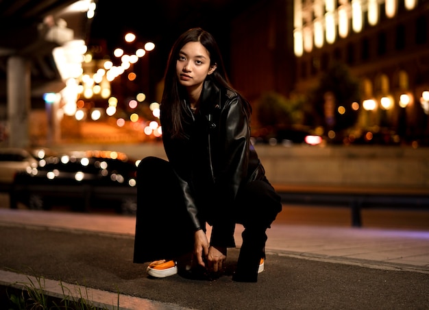 Portrait of beautiful woman in the city at night