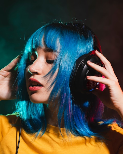 Portrait beautiful woman dj putting headphones