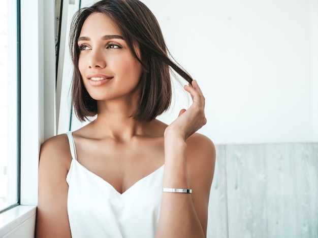 Portrait of beautiful woman dressed in white pajamas. 