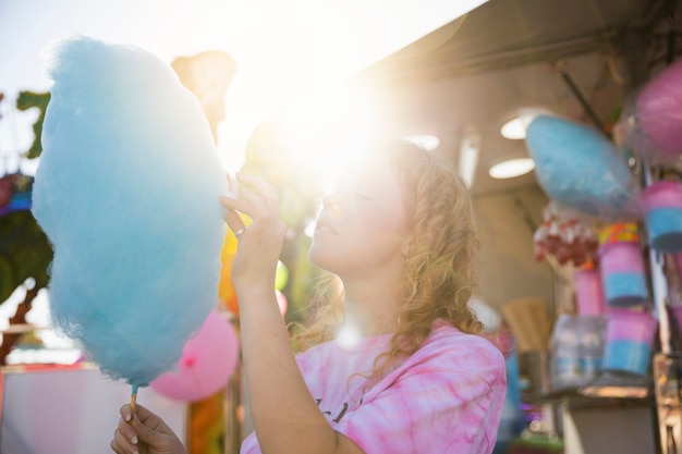 Free photo portrait beautiful woman eating cotton candy