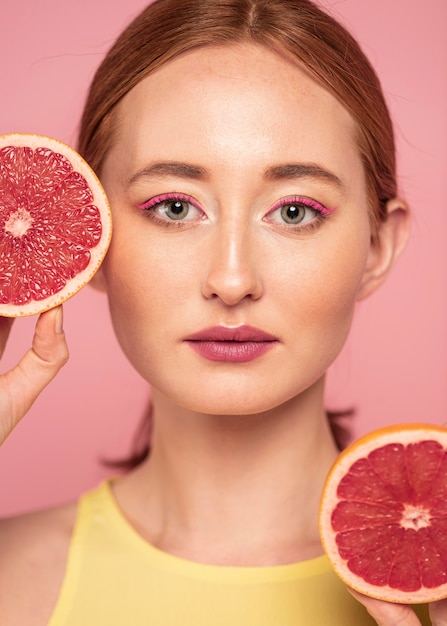 Portrait of beautiful woman holding fruits