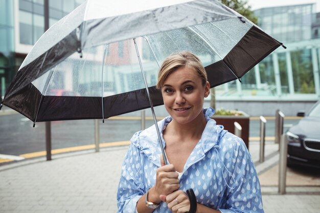 Portrait of beautiful woman holding umbrella